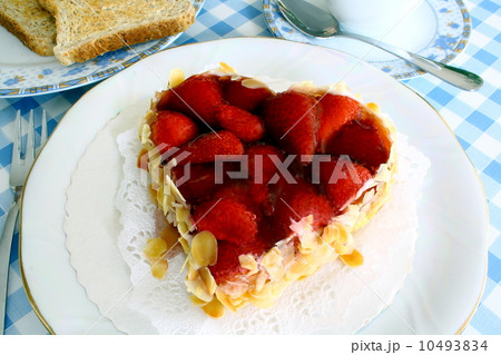 Strawberry cake with almond in heart shape with toast Strawberry cake with almond in heart shape with toast 10493834