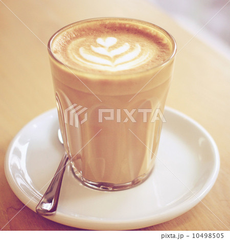 Cup of art latte or cappuccino coffee with retro filter effect 10498505