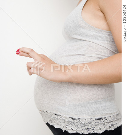 Pregnant woman with fingers crossed Pregnant woman with fingers crossed 10503424