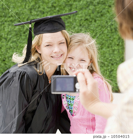 Graduate mother and daughter having photograph taken Graduate mother and daughter having photograph taken 10504015