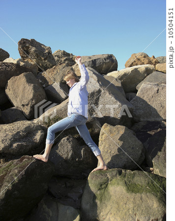 Woman climbing on rocks 10504151