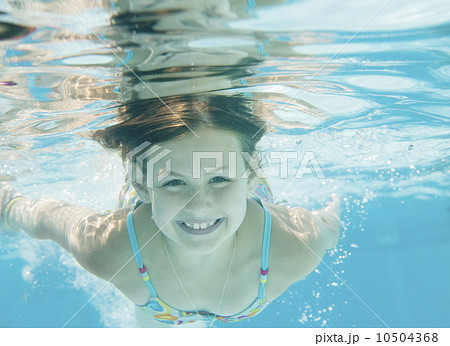 Girl swimming underwater 10504368