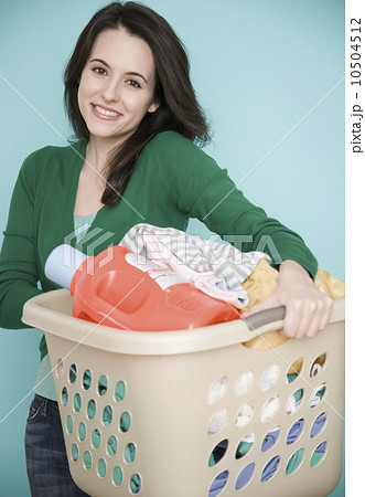 Portrait of woman carrying laundry basket 10504512