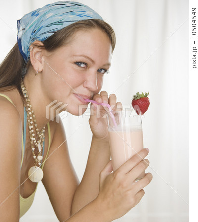 Young woman drinking smoothie with straw 10504549