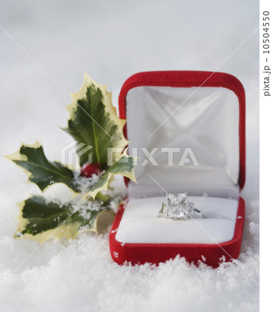 Engagement ring in box in snow 10504550