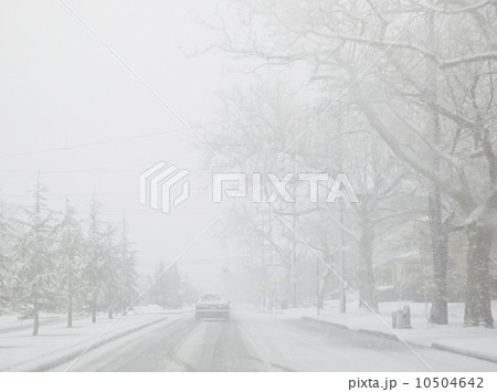 USA, New York State, Rockaway Beach, car on road during blizzard 10504642