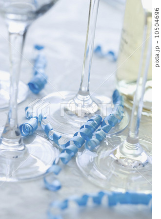 Close up of wine glasses and curled ribbon Close up of wine glasses and curled ribbon 10504696