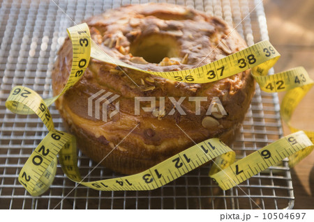 Studio Shot of bundt cake and tape measure Studio Shot of bundt cake and tape measure 10504697