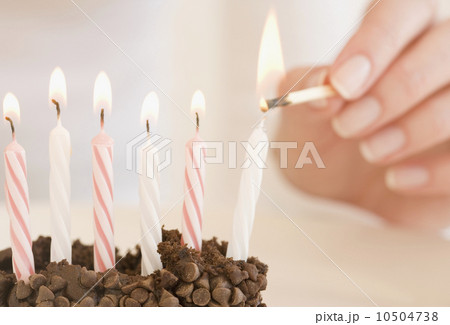 Woman lighting birthday candles 10504738