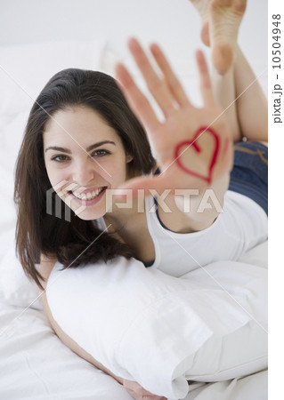 Woman with a heart drawn on her hand Woman with a heart drawn on her hand 10504948