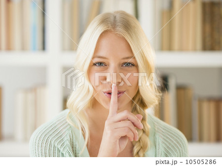 Portrait of woman with finger on lips Portrait of woman with finger on lips 10505286