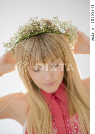 Portrait of woman wearing flower wreath Portrait of woman wearing flower wreath 10505341