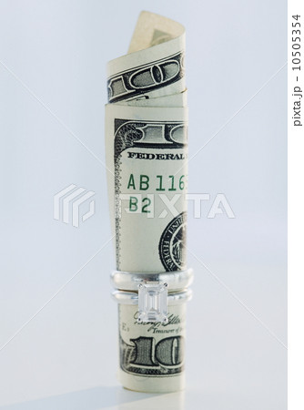 One hundred dollar bill rolled up in wedding ring 10505354