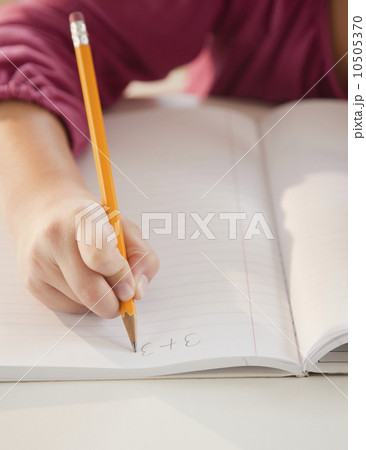 Young girl doing math homework 10505370