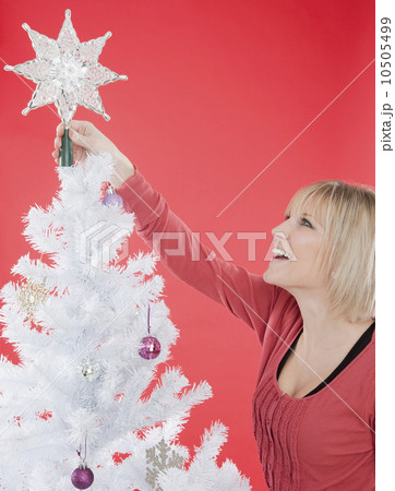 Woman decorating Christmas tree 10505499