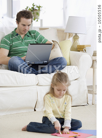 Father and daughter relaxing in livingroom Father and daughter relaxing in livingroom 10505556