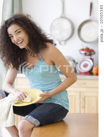 Woman drying off dish Woman drying off dish 10505585