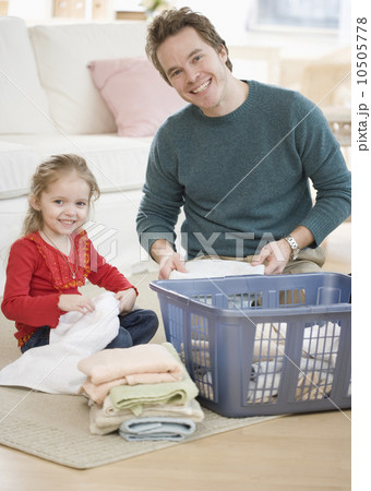 Father and daughter folding laundry Father and daughter folding laundry 10505778