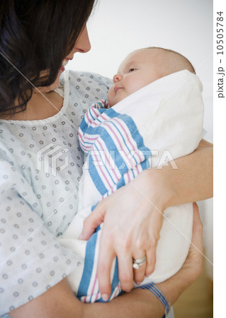 USA, New Jersey, Jersey City, Portrait of mother embracing baby girl (2-5 months) 10505784
