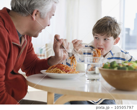 Father and son eating spaghetti Father and son eating spaghetti 10505797