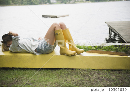 Roaring Brook Lake, Woman lying on pier by lake Roaring Brook Lake, Woman lying on pier by lake 10505839