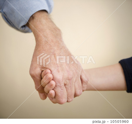 Close up grandfather and grandson (8-9) holding hands 10505960