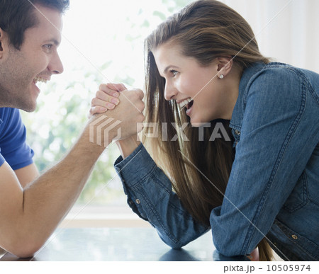 Happy young couple hand wrestling 10505974