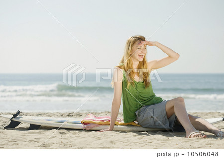 Woman sitting on surfboard Woman sitting on surfboard 10506048