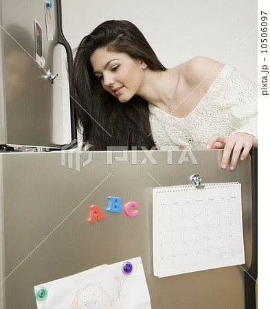 Woman looking in refrigerator Woman looking in refrigerator 10506097