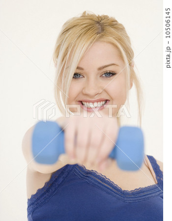 Woman holding dumbbell 10506145