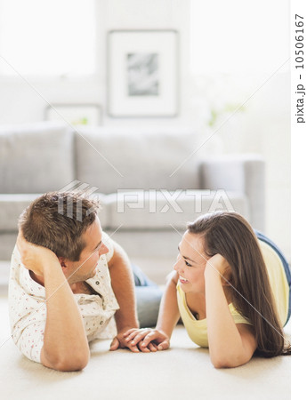 Portrait of happy couple lying on side, face to face Portrait of happy couple lying on side, face to face 10506167