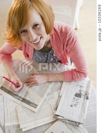 Young woman circling ads in newspaper 10506269