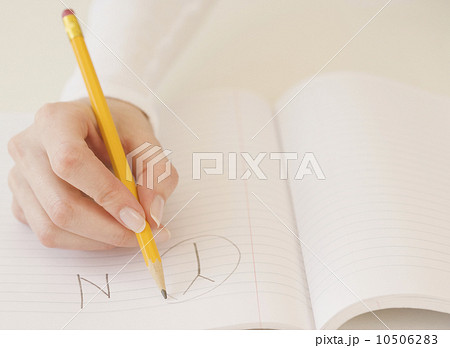 Woman circling the letter Y in notebook Woman circling the letter Y in notebook 10506283