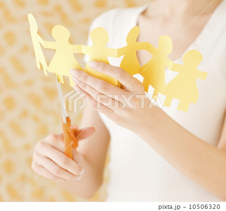 Woman cutting out paper dolls 10506320