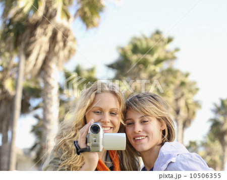 Two women looking at video camera Two women looking at video camera 10506355