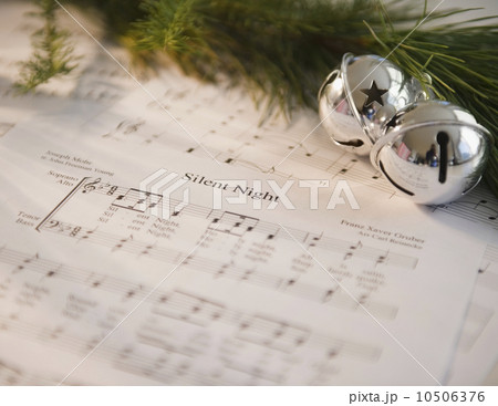 Christmas baubles on carol music sheet  10506376