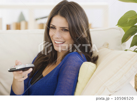 Woman pointing remote control Woman pointing remote control 10506520