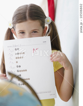 Child holding up grades 10506602