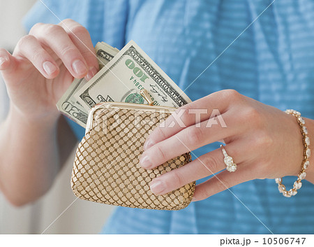 Woman pulling money from change purse 10506747