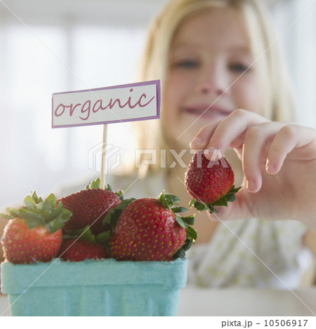 USA, New Jersey, Jersey City, Girl (8-9) eating organic strawberries 10506917