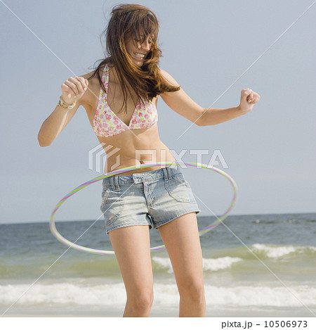Young woman playing with hula hoop 10506973