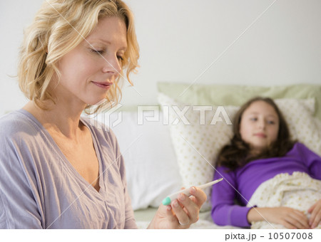 Mother checking temperature to daughter (8-9)  10507008