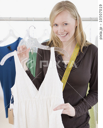 Woman holding dress in clothing store Woman holding dress in clothing store 10507019