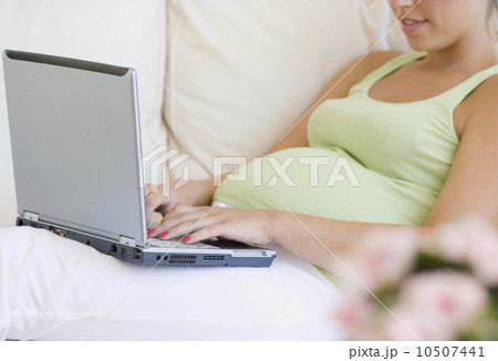 Pregnant woman typing on laptop Pregnant woman typing on laptop 10507441