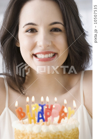 Portrait of woman next to birthday cake Portrait of woman next to birthday cake 10507535