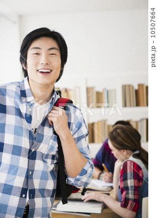 Portrait of cheerful student in library 10507664