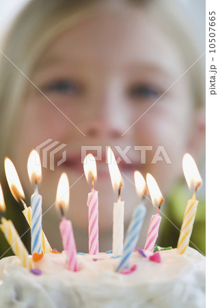 USA, New Jersey, Jersey City, Girl (8-9) in front of birthday cake 10507665