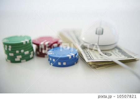 Roulette tokens, dollar bills and computer mouse 10507821