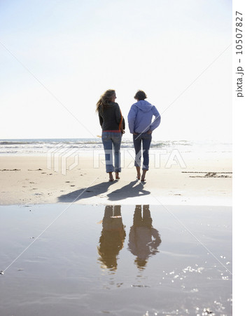 Two women walking on beach Two women walking on beach 10507827