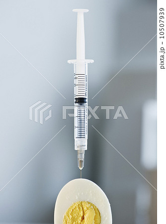 Syringe in a sliced egg 10507939